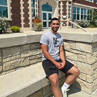 Geyer Hall with student on bench