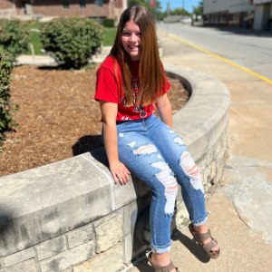 student sitting on ledge in front of Geyer Hall