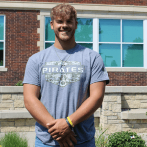 Student wearing a gray NCMC shirt in front of Geyer Hall