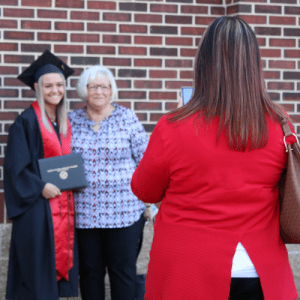 Graduate getting picture with their supporter