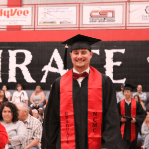 Graduate student walking during commencement