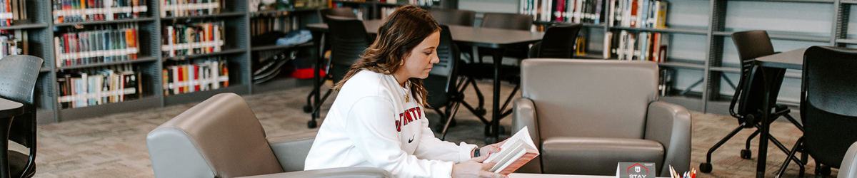 Student reading comfortably in the library