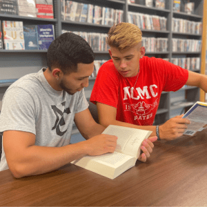 Two students reading together