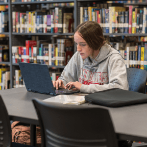 Student at their laptop in the Library