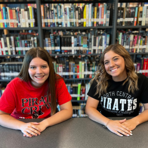 Student students in front of book shelves