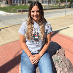Student sitting on stone marker